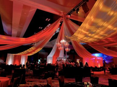 Circus tent ceiling drape event design with lighting design